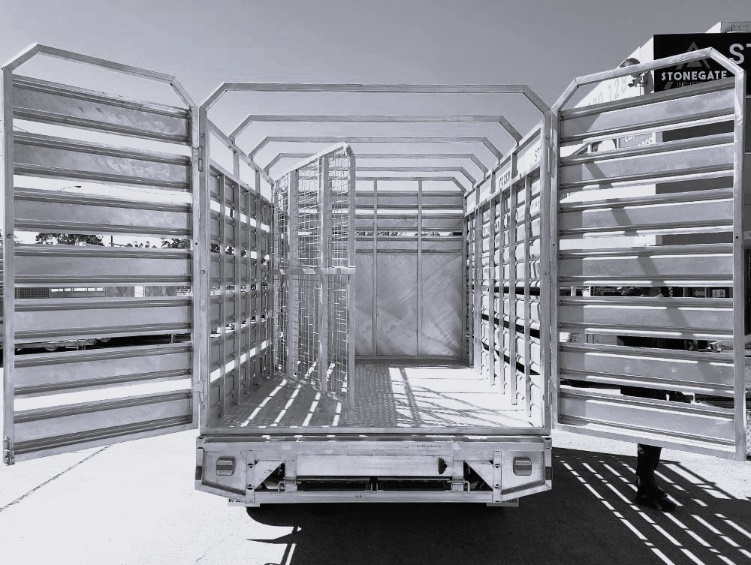 Large flat top trailer with drop sides and slide-out ramps